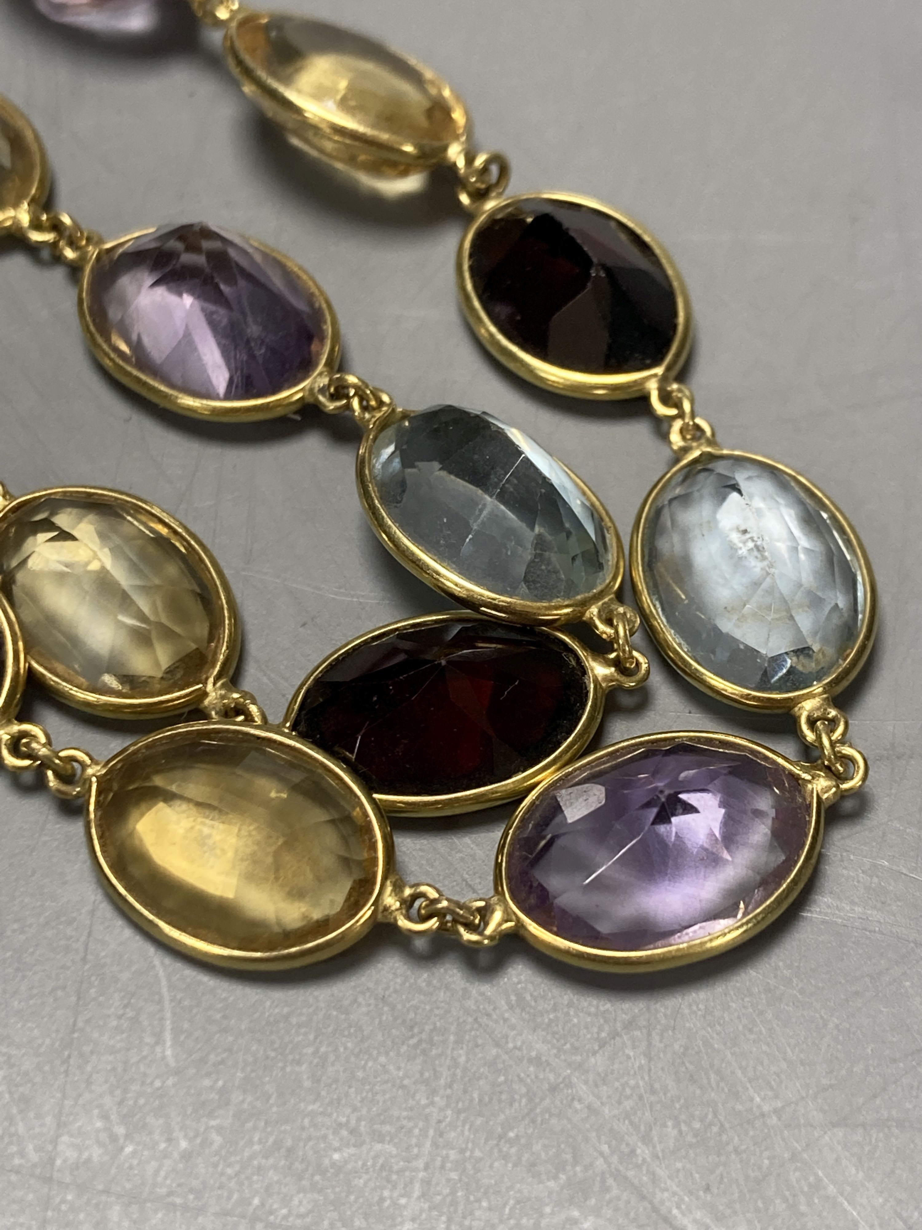 An 18ct gold multi gem spectacle set necklace, 48cm.